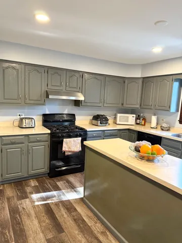 a kitchen with a refrigerator and a sink