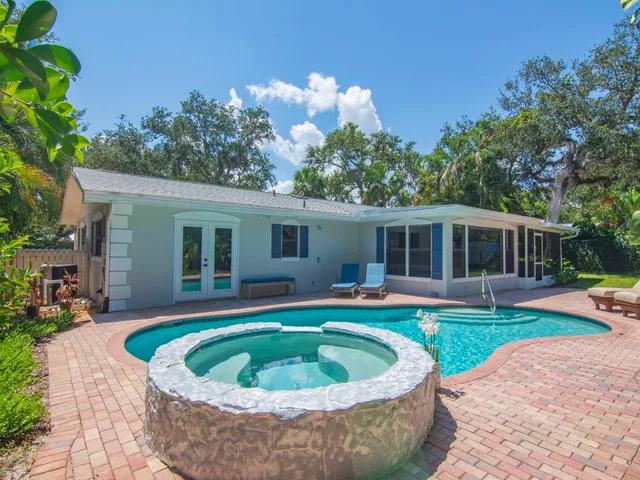 a house with a swimming pool in front of it
