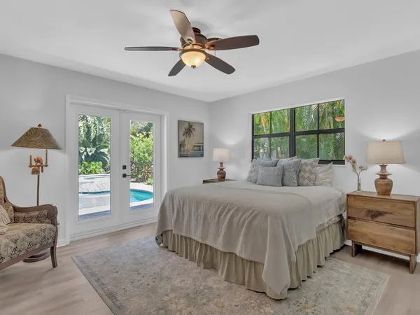 a bedroom with a large bed and a chandelier