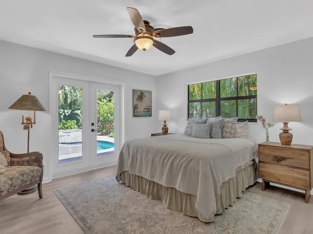 a bedroom with a large bed and a chandelier