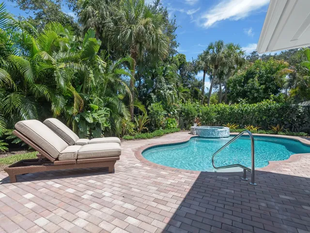 a view of a chairs and table in the backyard