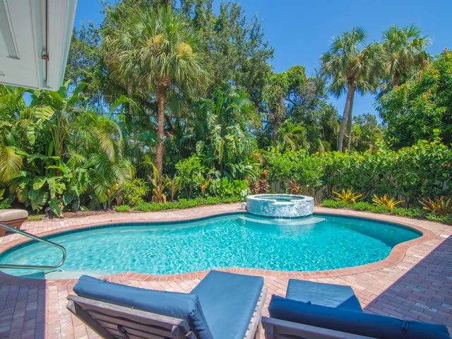 a view of a swimming pool with a outdoor seating