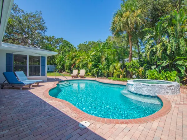 a swimming pool with outdoor seating and yard
