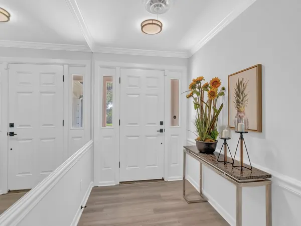 a view of an entryway with wooden floor