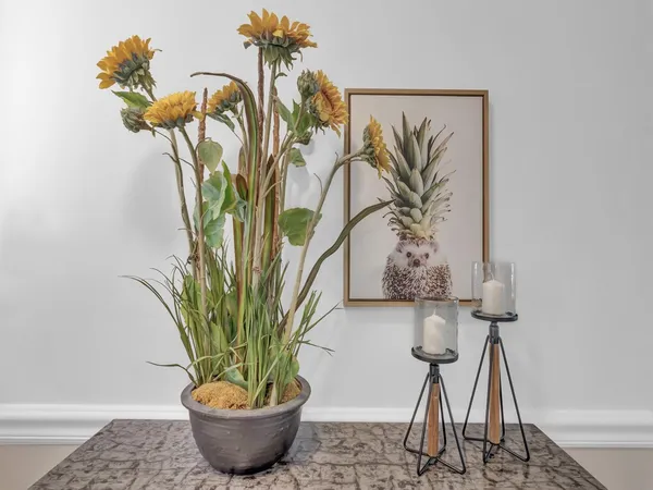a view of a vase of flowers sitting on a table with six mirrors