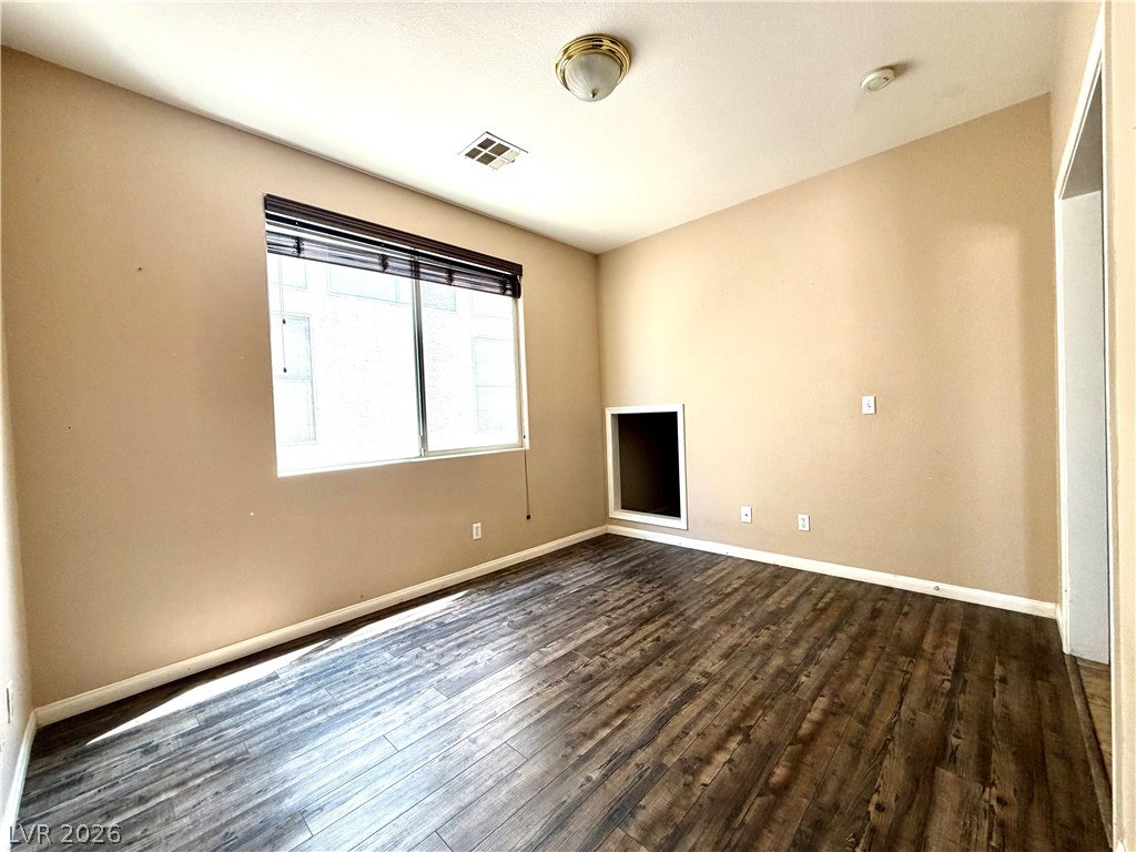 3936 Gold Point Street Las Vegas, NV 89129 - Photo 6 of 23 Laminate flooring throughout highlights this versatile interior space, ready for your personal touch.