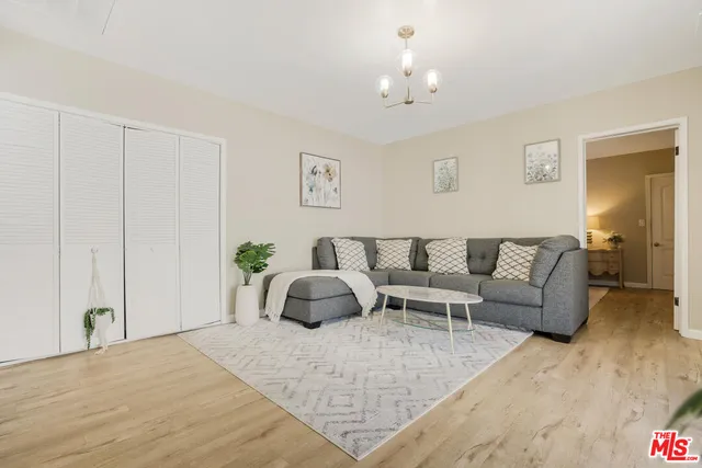 a living room with furniture and a chandelier