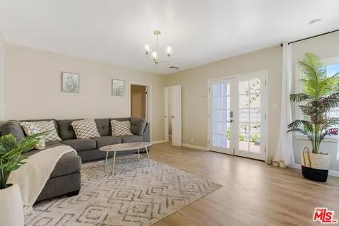 a living room with furniture and wooden floor