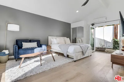 a bedroom with bed and a table