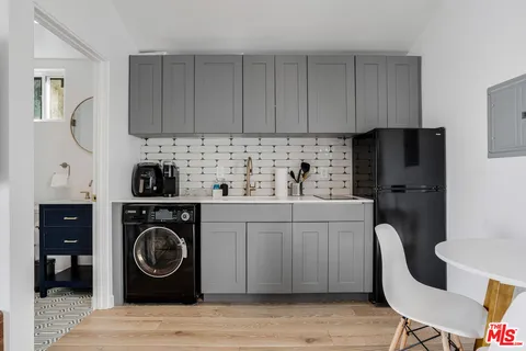 a kitchen with a sink a stove and cabinets