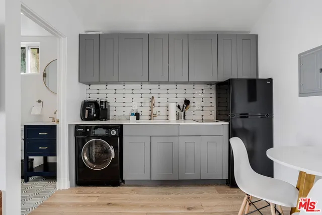 a kitchen with a sink a stove and cabinets