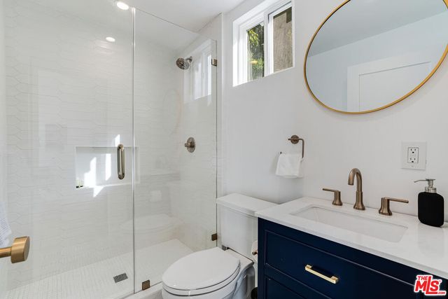 a bedroom with a bed and large windows