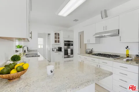 a kitchen with stainless steel appliances granite countertop a stove and a sink