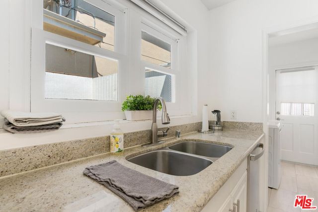 a kitchen with a sink and a mirror