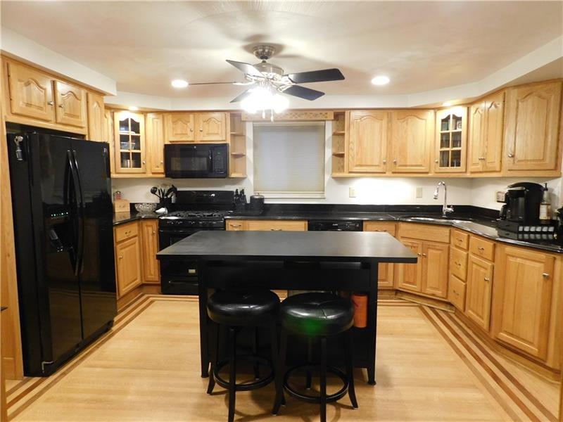 2285 Monroeville Road Monroeville, PA 15146 - Photo 7 of 24 YOU WILL ENJOY THE LARGE KITCHEN WITH ENDLESS STORAGE AND LOTS OF LIGHTING. YOU CAN EAT ON THE ISLAND IF YOU DO NOT FEEL LIKE A FORMAL SIT DOWN IN THE DINING ROOM.