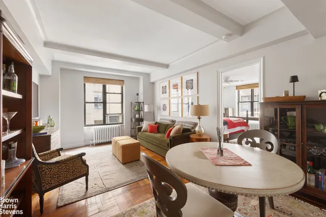 a living room with furniture a flat screen tv and a dining table