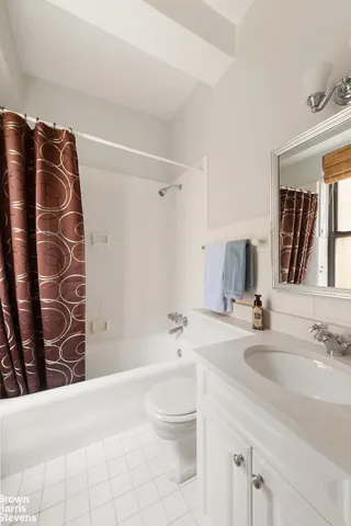 a kitchen with granite countertop white cabinets and a stove