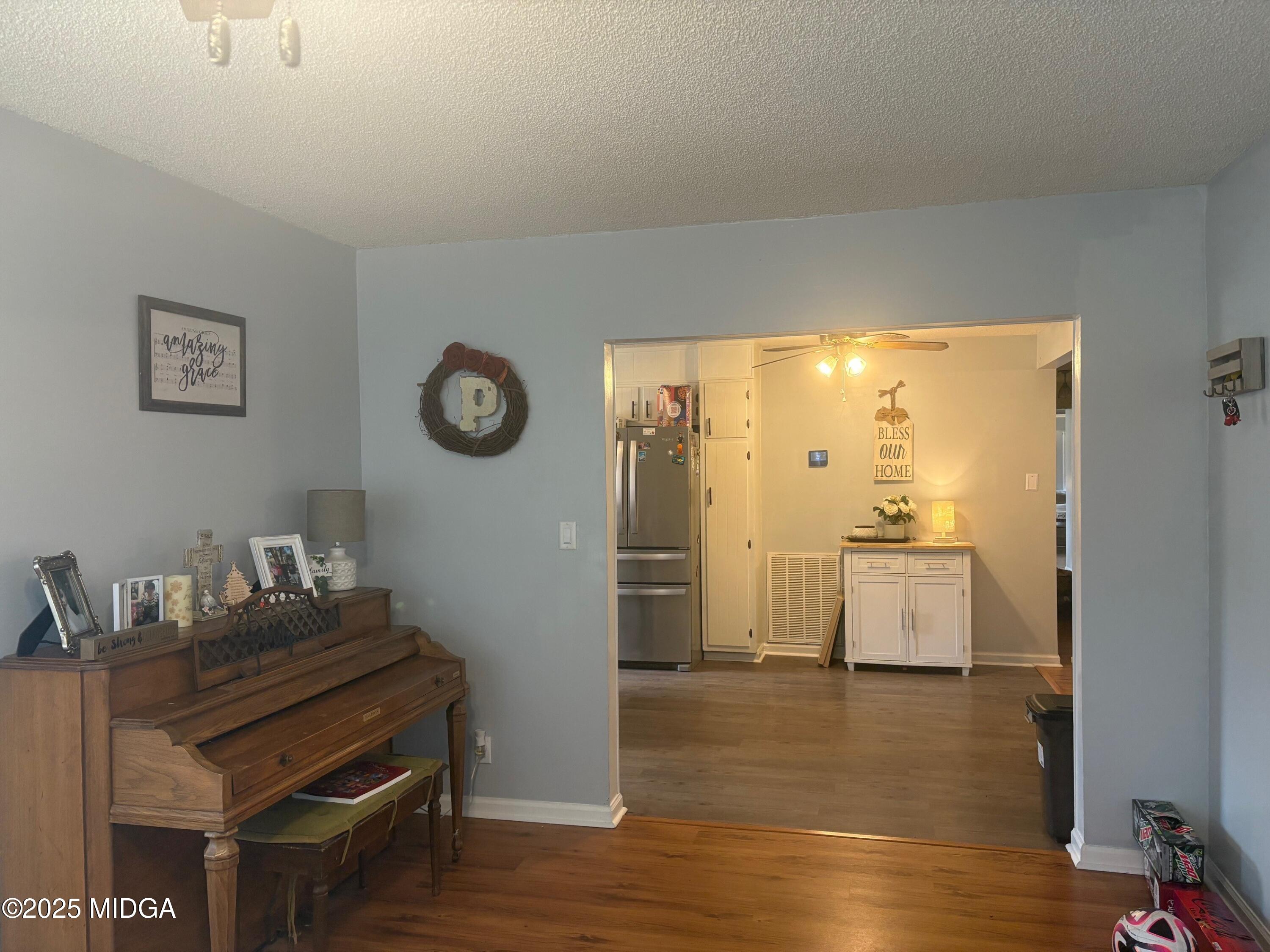 132 Old Hickory Road Byron, GA 31008 - Photo 13 of 35 a view of a kitchen with fridge and wooden floor