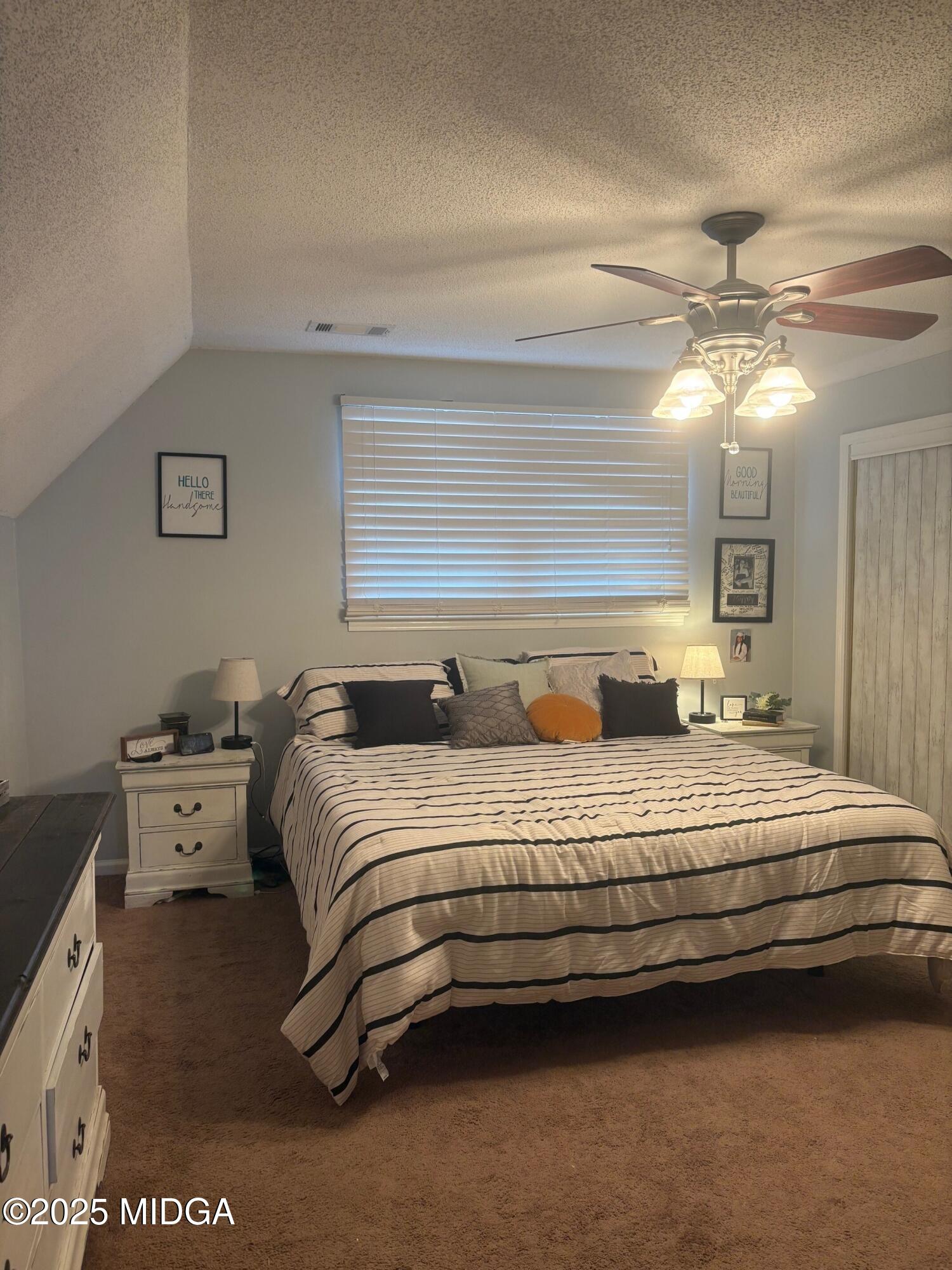 132 Old Hickory Road Byron, GA 31008 - Photo 14 of 35 a bedroom with bed and a chandelier