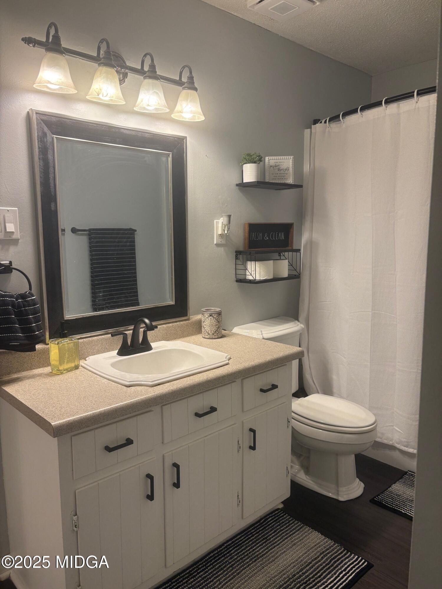 132 Old Hickory Road Byron, GA 31008 - Photo 18 of 35 a bathroom with a toilet sink and mirror
