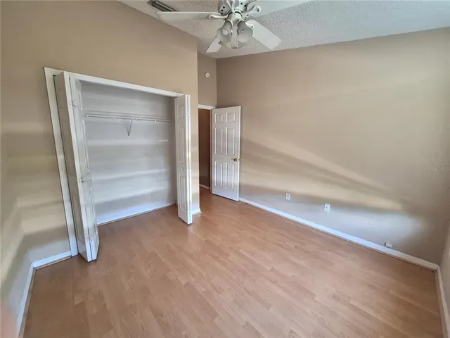a view of an empty room with a ceiling fan
