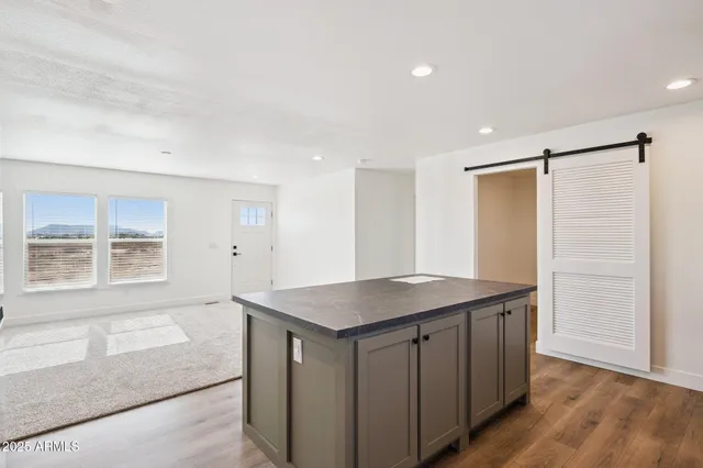 a bathroom with a granite countertop sink a mirror and a shower