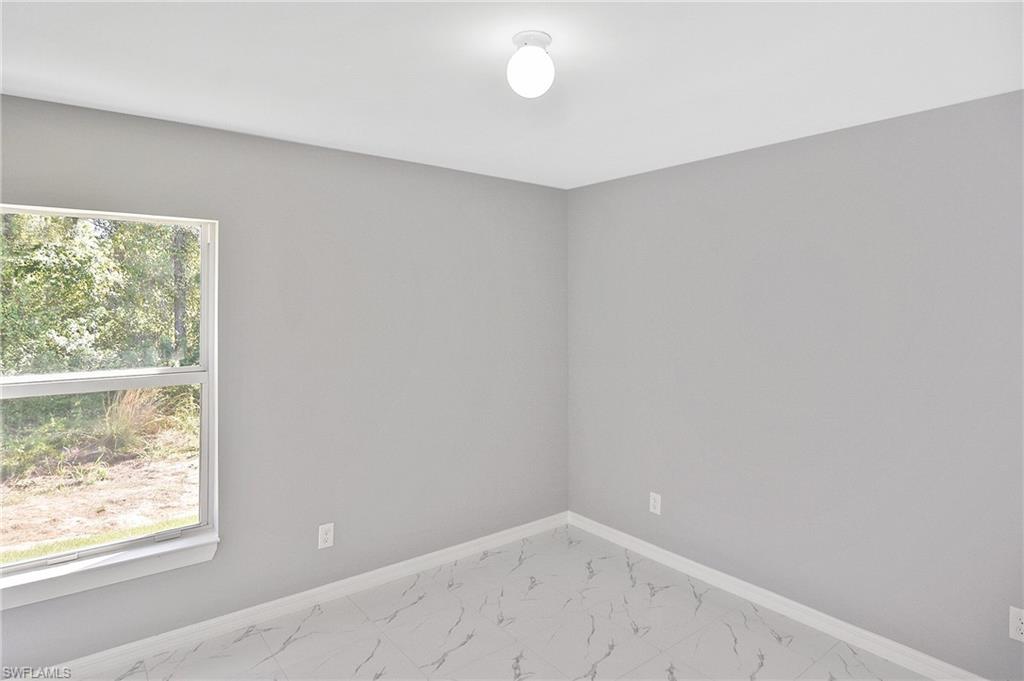 3306 1st Street Southwest Lehigh Acres, FL 33976 - Photo 12 of 47 an empty room with a window