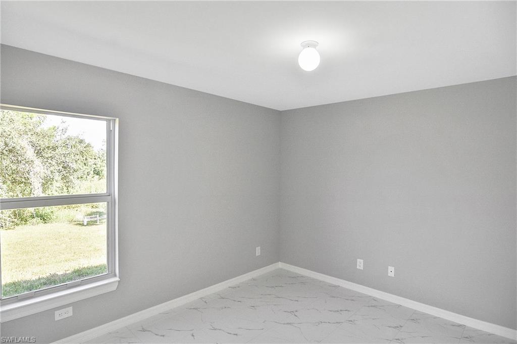 3306 1st Street Southwest Lehigh Acres, FL 33976 - Photo 16 of 47 a view of empty room with window