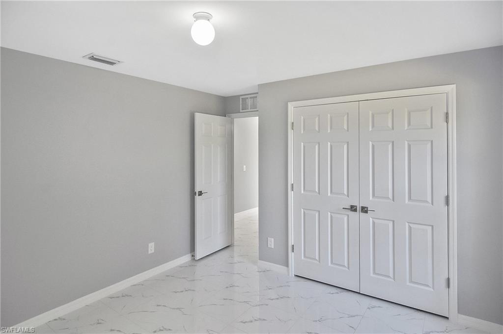 3306 1st Street Southwest Lehigh Acres, FL 33976 - Photo 18 of 47 an empty room with white walls