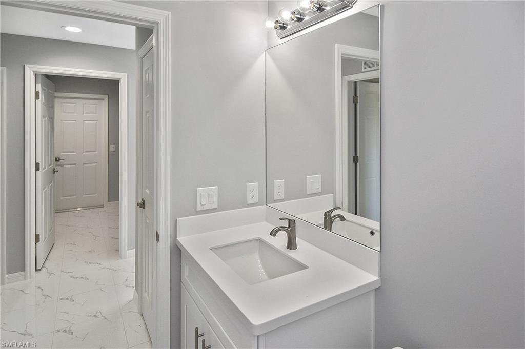 3306 1st Street Southwest Lehigh Acres, FL 33976 - Photo 20 of 47 a bathroom with a sink and a mirror