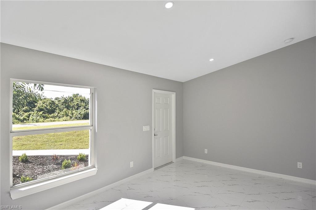 3306 1st Street Southwest Lehigh Acres, FL 33976 - Photo 21 of 47 a view of an empty room with a window
