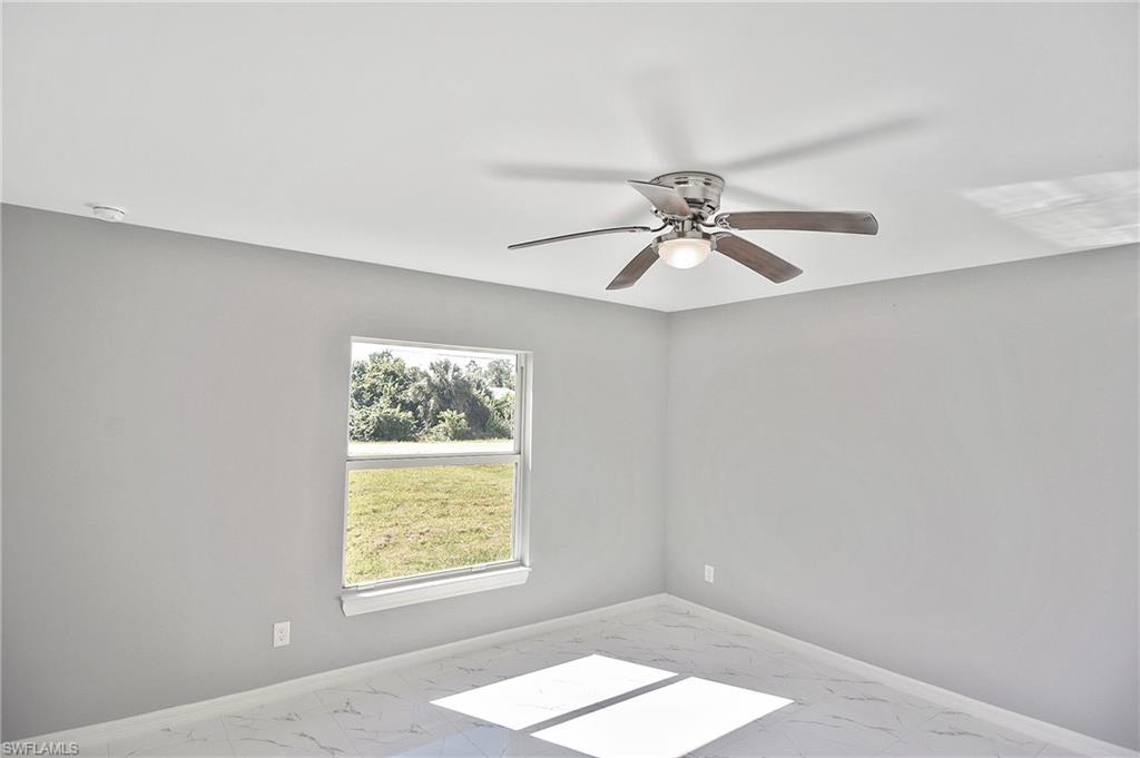 3306 1st Street Southwest Lehigh Acres, FL 33976 - Photo 24 of 47 an empty room with windows and fan