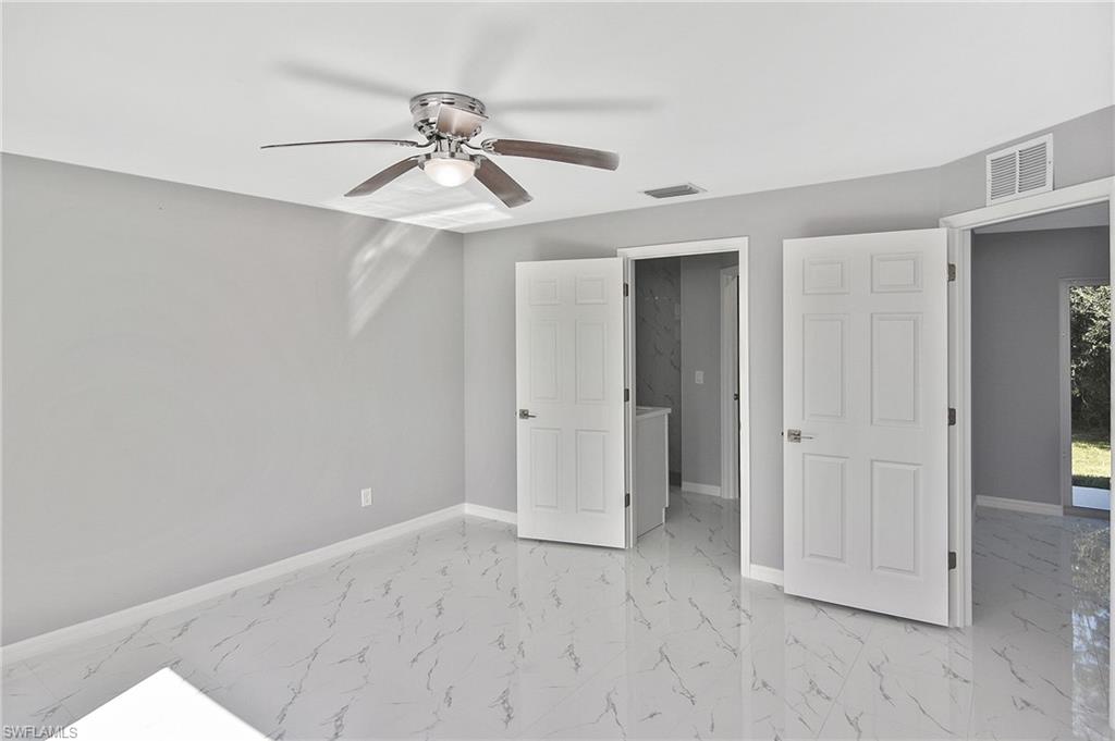 3306 1st Street Southwest Lehigh Acres, FL 33976 - Photo 25 of 47 wooden floor in an empty room