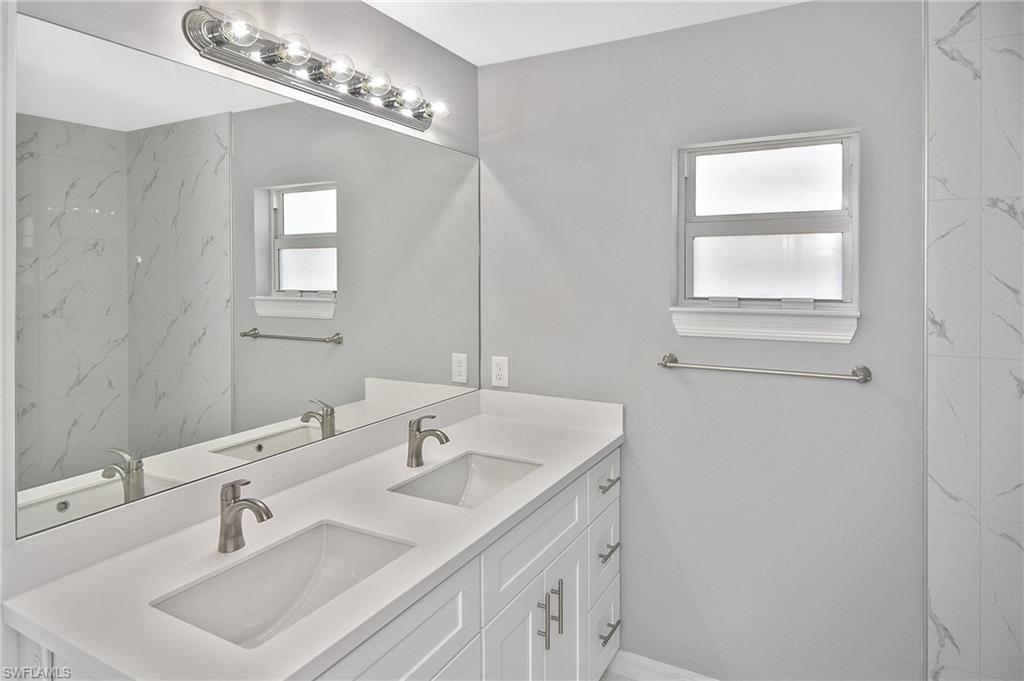 3306 1st Street Southwest Lehigh Acres, FL 33976 - Photo 28 of 47 a bathroom with a sink and a mirror
