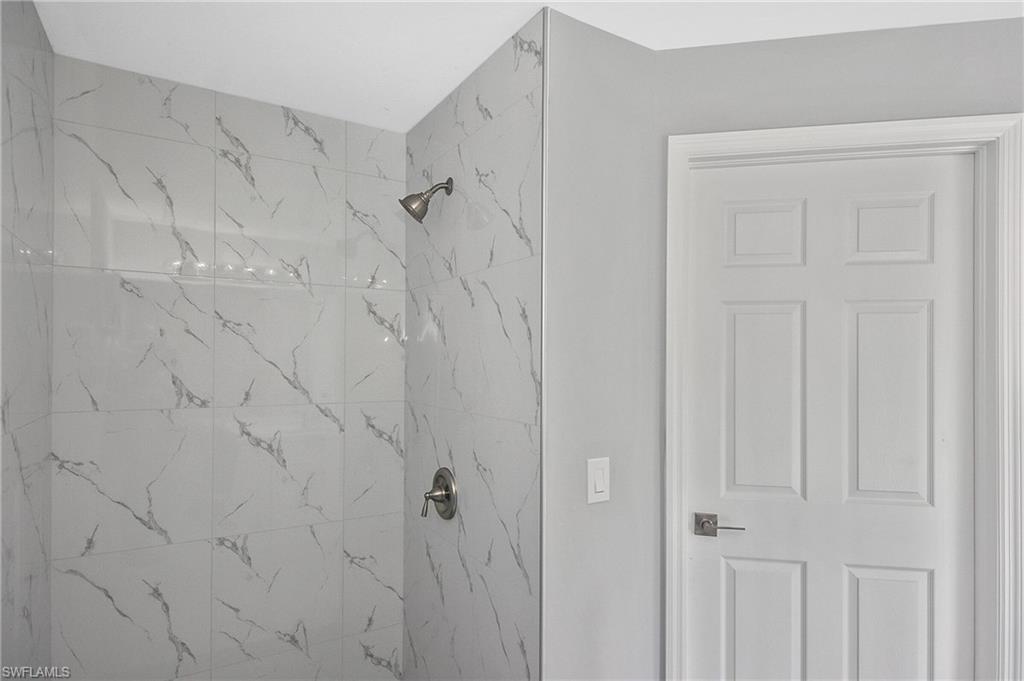3306 1st Street Southwest Lehigh Acres, FL 33976 - Photo 29 of 47 a bathroom with a shower