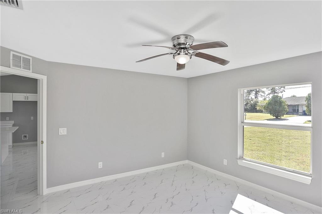 3306 1st Street Southwest Lehigh Acres, FL 33976 - Photo 31 of 47 a view of an empty room with a window