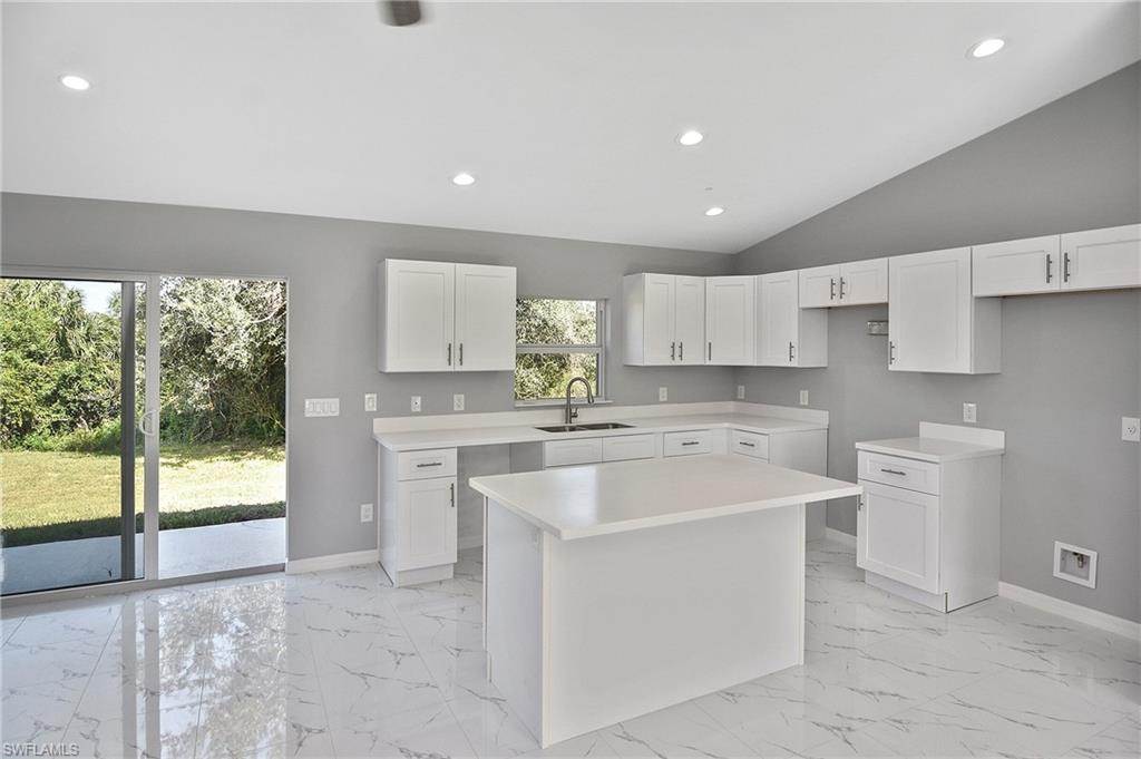 3306 1st Street Southwest Lehigh Acres, FL 33976 - Photo 34 of 47 a kitchen that has a sink and a stove in it