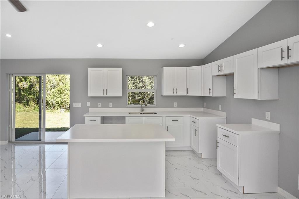 3306 1st Street Southwest Lehigh Acres, FL 33976 - Photo 35 of 47 a kitchen with white cabinets and white appliances