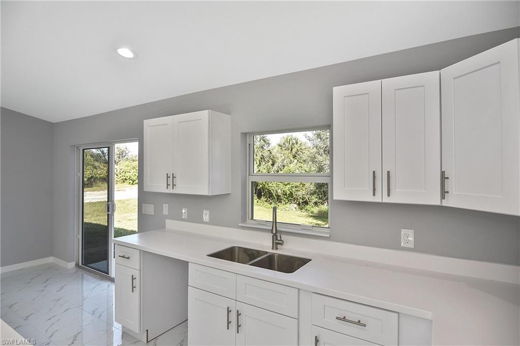 3306 1st Street Southwest Lehigh Acres, FL 33976 - Photo 38 of 47 a kitchen with a sink and window