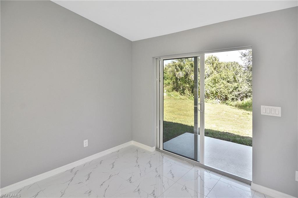 3306 1st Street Southwest Lehigh Acres, FL 33976 - Photo 40 of 47 an empty room with glass windows