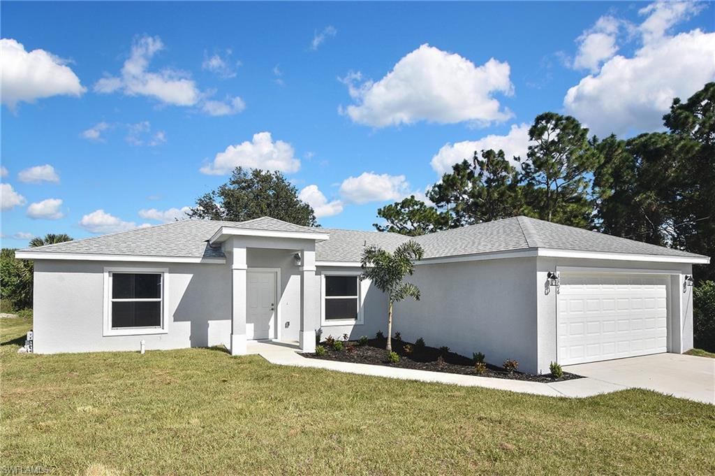 3306 1st Street Southwest Lehigh Acres, FL 33976 - Photo 4 of 47 a view of a house with a yard
