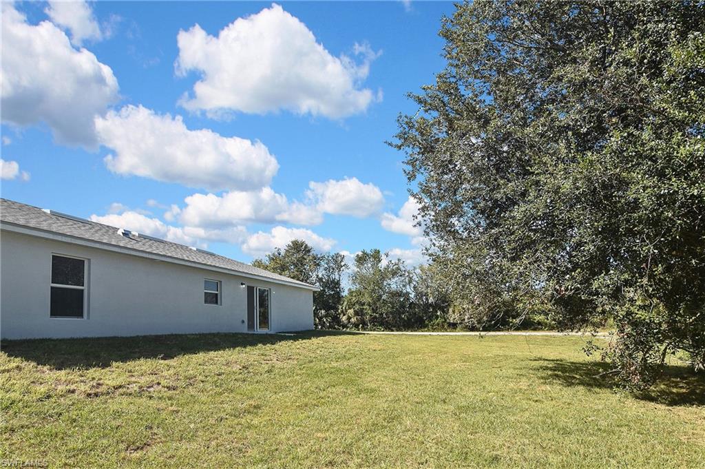 3306 1st Street Southwest Lehigh Acres, FL 33976 - Photo 45 of 47 a backyard of a house
