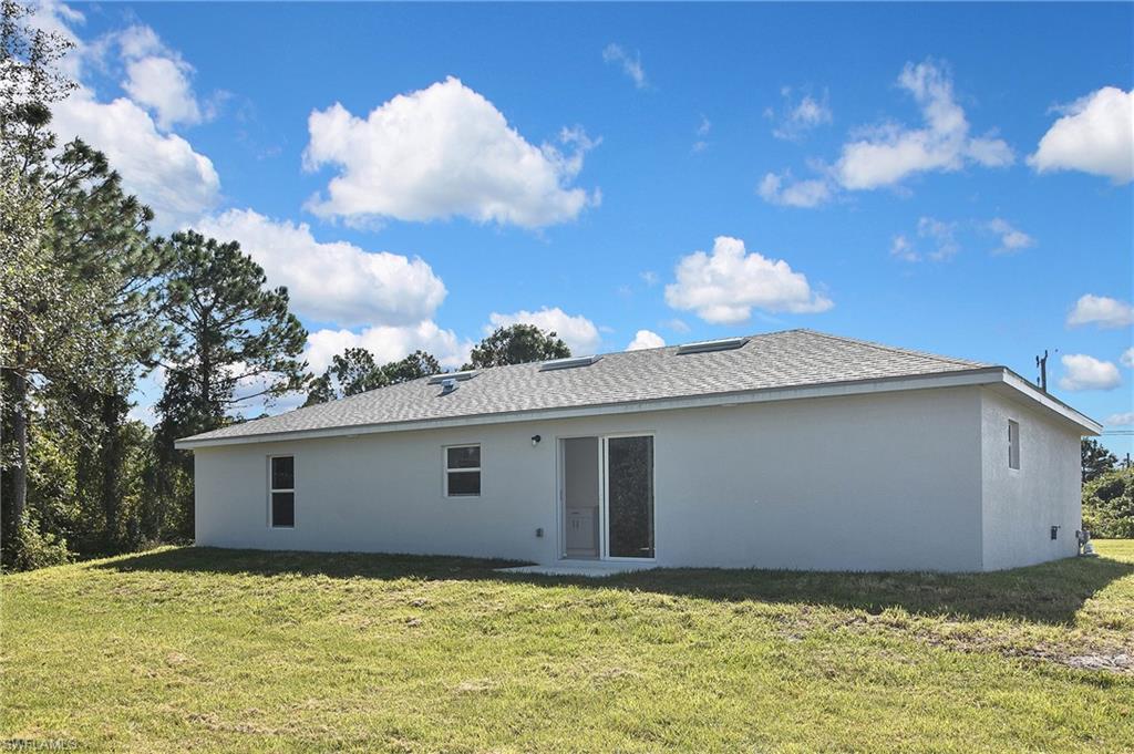 3306 1st Street Southwest Lehigh Acres, FL 33976 - Photo 47 of 47 a view of a house with a yard