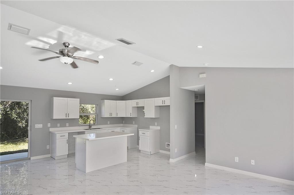 3306 1st Street Southwest Lehigh Acres, FL 33976 - Photo 7 of 47 a view of kitchen with center island and stainless steel appliances