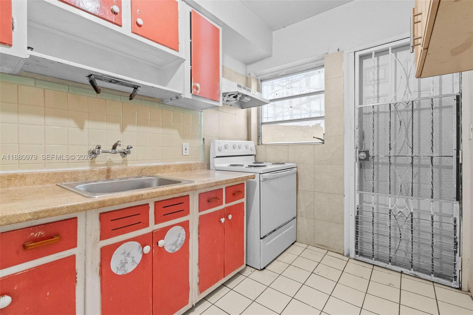 1345 Southwest 7th Street Miami, FL 33135 - Photo 13 of 37 a kitchen with stainless steel appliances granite countertop a sink and a stove