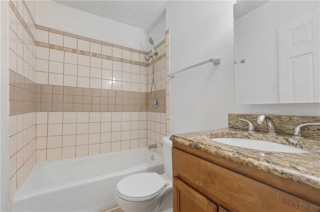 2139 Trailwood Road Decatur, GA 30032 - Photo 11 of 21 a bathroom with a granite countertop bathtub shower sink vanity and toilet
