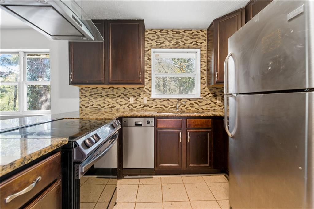 2139 Trailwood Road Decatur, GA 30032 - Photo 3 of 21 a kitchen with stainless steel appliances granite countertop a refrigerator and a sink