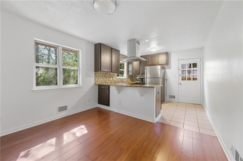 2139 Trailwood Road Decatur, GA 30032 - Photo 6 of 21 a view of kitchen with wooden floor electronic appliances and window