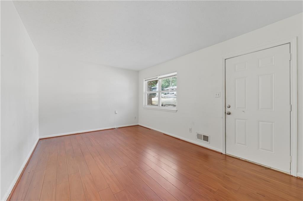 2139 Trailwood Road Decatur, GA 30032 - Photo 8 of 21 an empty room with wooden floor and windows