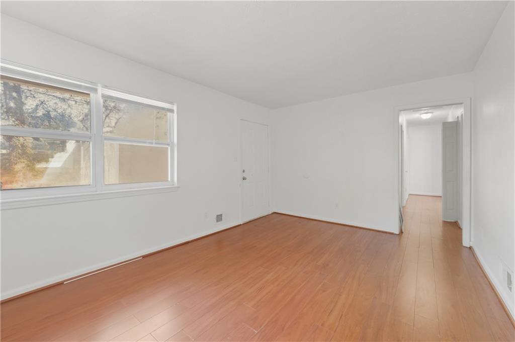 2139 Trailwood Road Decatur, GA 30032 - Photo 9 of 21 an empty room with wooden floor and windows